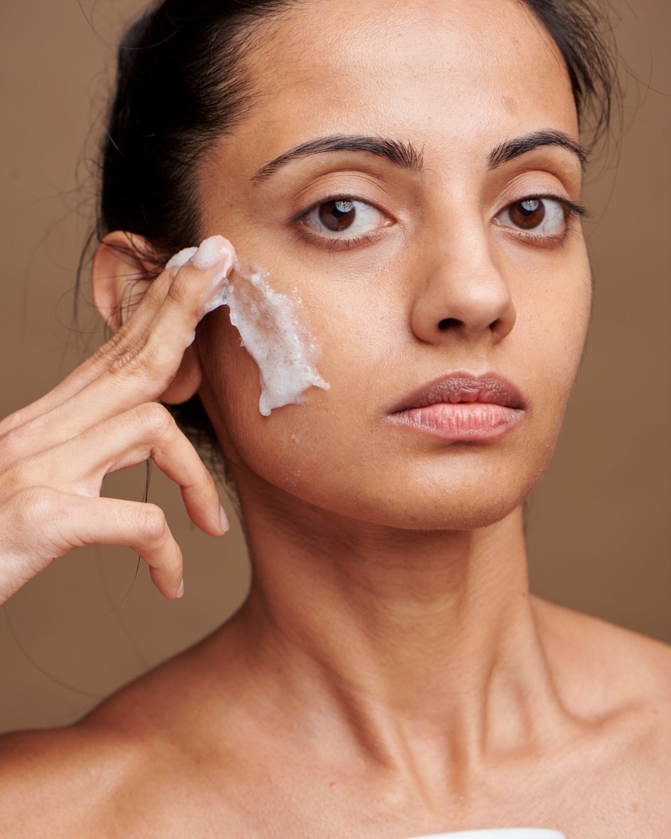 Woman Applying Skincare on Face